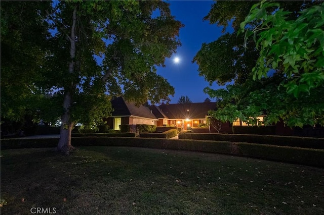 view of yard at twilight