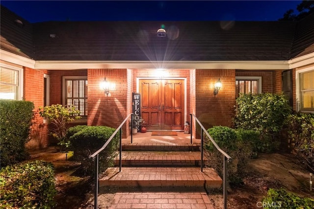 exterior entry at twilight with covered porch