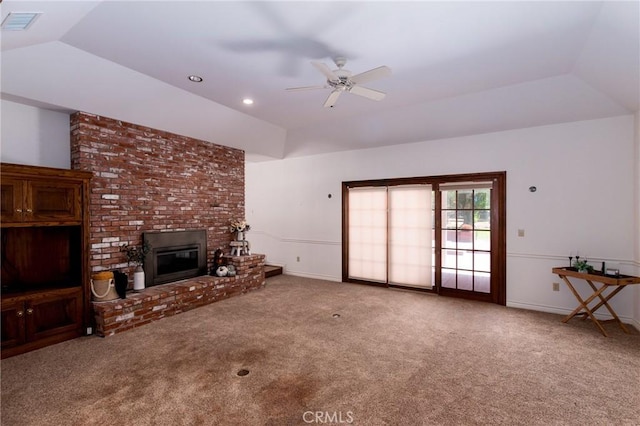 unfurnished living room featuring a fireplace, carpet floors, vaulted ceiling, and ceiling fan