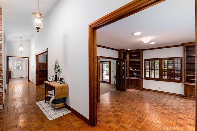 hall with crown molding and parquet floors