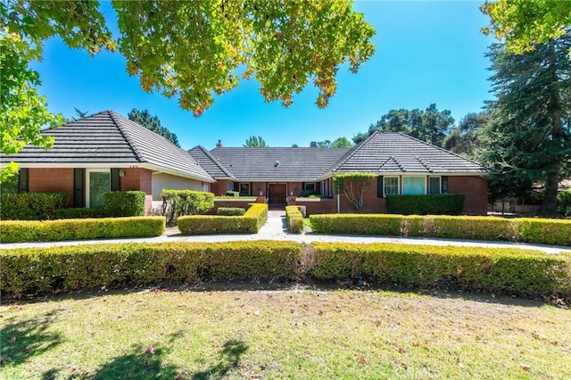 ranch-style house with a front lawn