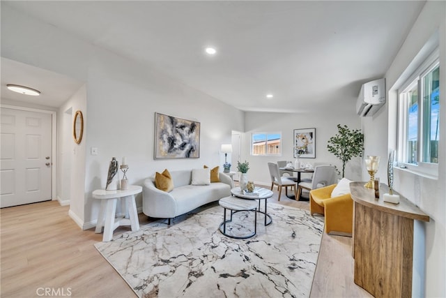 living room with light hardwood / wood-style floors, lofted ceiling, and a wall unit AC