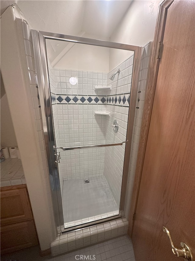 bathroom with tile patterned floors and walk in shower