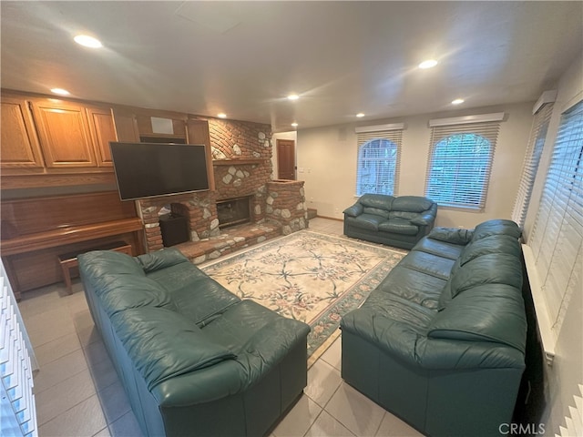 tiled living room featuring a stone fireplace