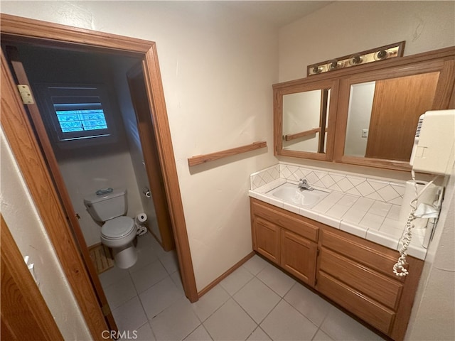 bathroom featuring toilet, tile patterned flooring, backsplash, and vanity