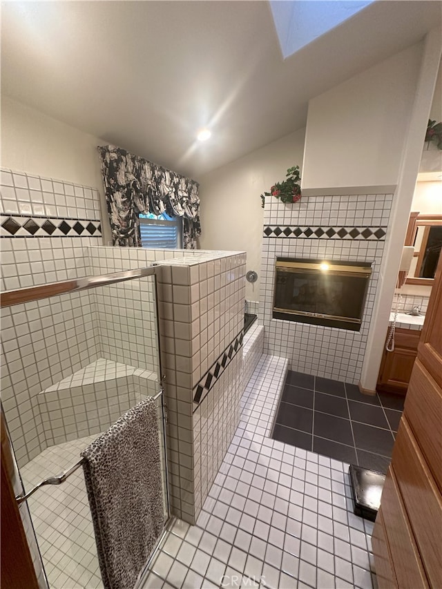 bathroom featuring a shower, tile patterned floors, and vanity