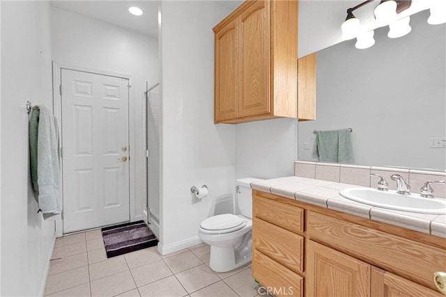 bathroom with tile patterned floors, walk in shower, vanity, and toilet