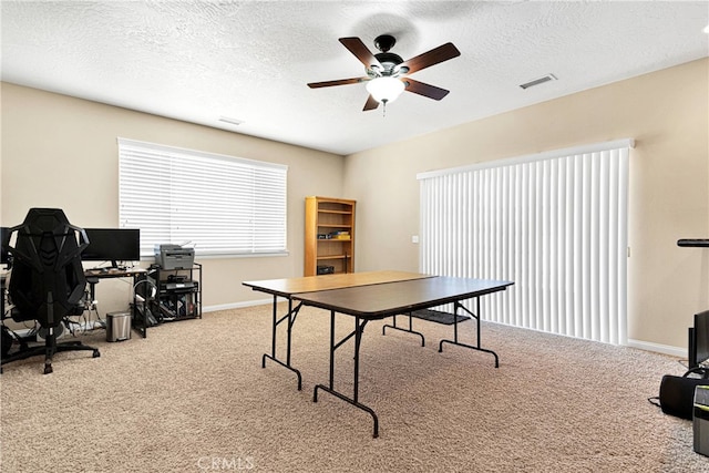 playroom featuring a textured ceiling, ceiling fan, and carpet floors