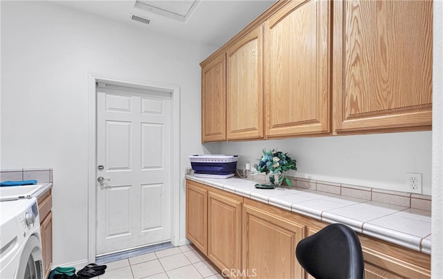 washroom with light tile patterned floors and cabinets