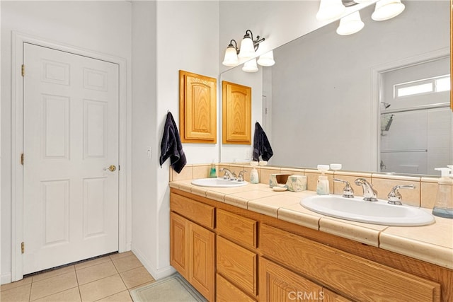 bathroom with vanity, tile patterned flooring, and an enclosed shower