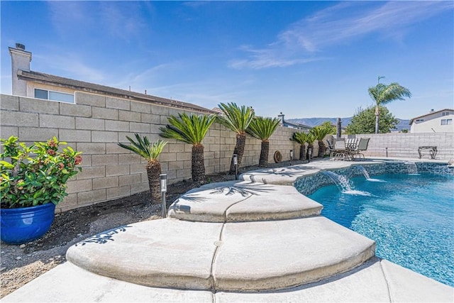 view of pool featuring a patio, a fenced in pool, and a fenced backyard