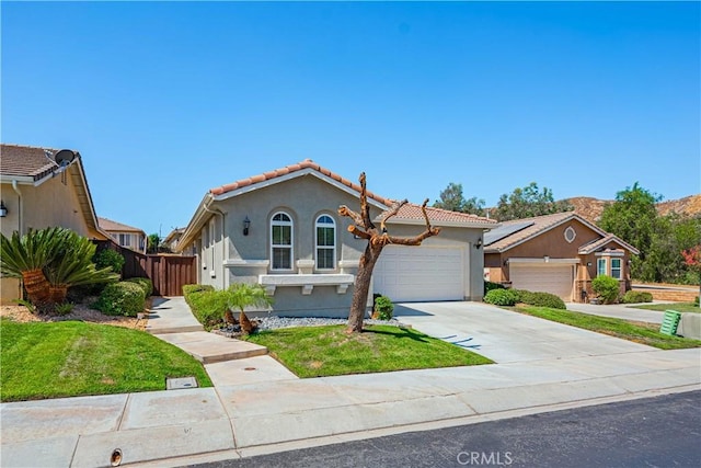 view of front of house featuring a garage and a front lawn