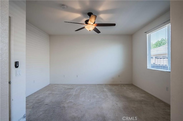 empty room featuring carpet and ceiling fan