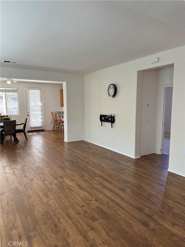 empty room with dark hardwood / wood-style flooring