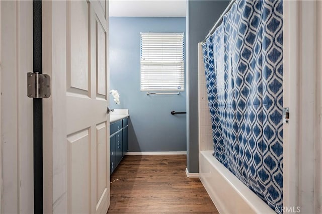 bathroom featuring hardwood / wood-style flooring, vanity, and shower / bath combo with shower curtain