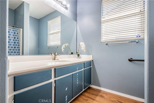 bathroom with hardwood / wood-style flooring and vanity