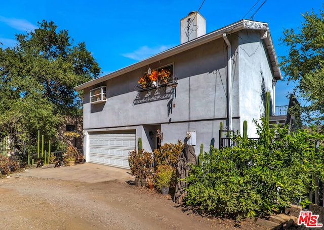 view of side of home with a garage