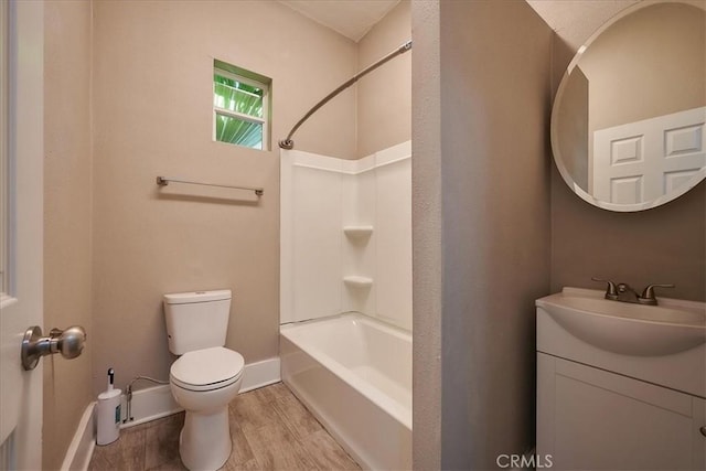 full bathroom featuring hardwood / wood-style floors, vanity,  shower combination, and toilet