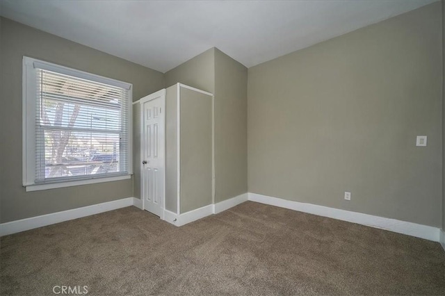 unfurnished bedroom with carpet and a closet