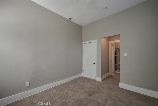 unfurnished room featuring light colored carpet