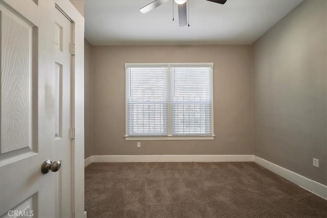 carpeted spare room featuring ceiling fan