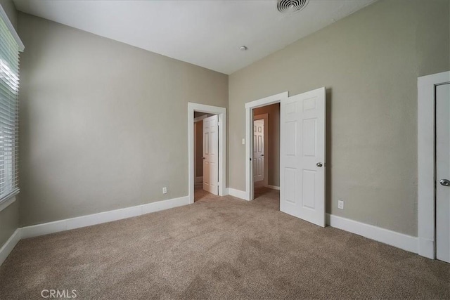 unfurnished bedroom featuring light carpet