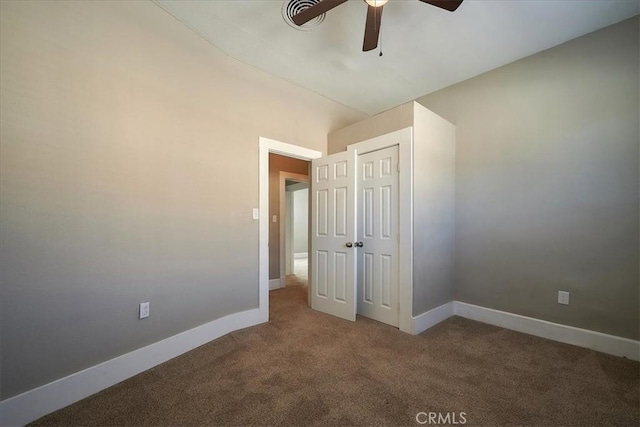 unfurnished bedroom featuring ceiling fan, carpet floors, and a closet