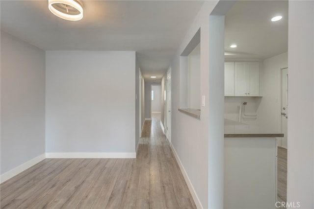 corridor with light hardwood / wood-style flooring