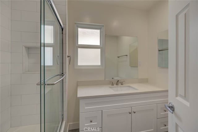 bathroom featuring walk in shower and vanity