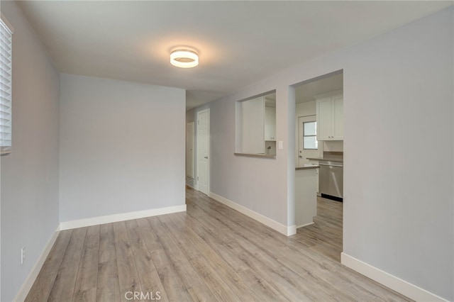 spare room featuring light wood-type flooring