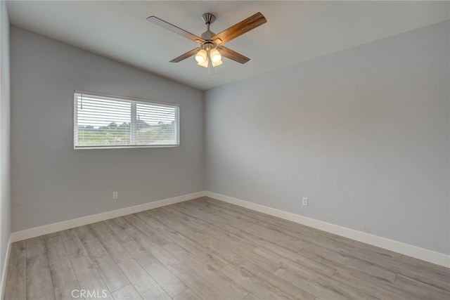 empty room featuring ceiling fan, lofted ceiling, and light hardwood / wood-style floors