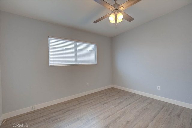 spare room featuring light wood-type flooring and ceiling fan