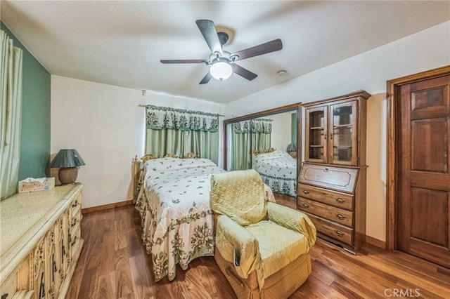 bedroom featuring ceiling fan and dark wood-type flooring