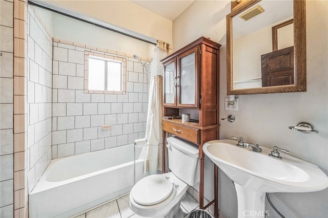 full bathroom featuring shower / tub combo with curtain, toilet, sink, and tile patterned floors