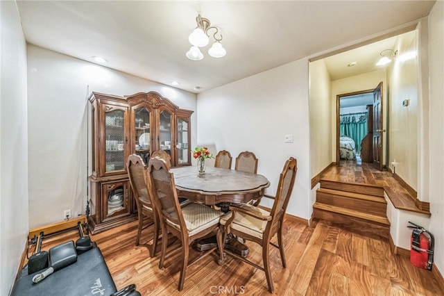 dining area featuring hardwood / wood-style floors and a chandelier