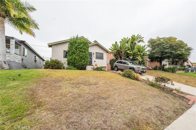 3927 W 58th Pl, Los Angeles, CA 90043 - view of property hidden behind natural elements with a front yard and stucco siding