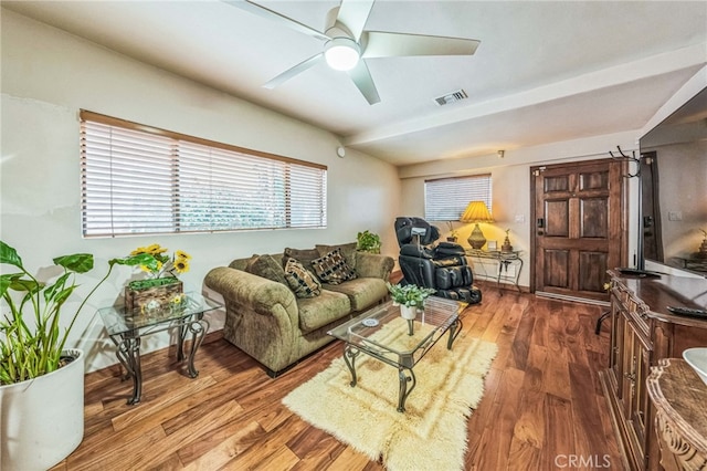 living room with wood-type flooring and ceiling fan