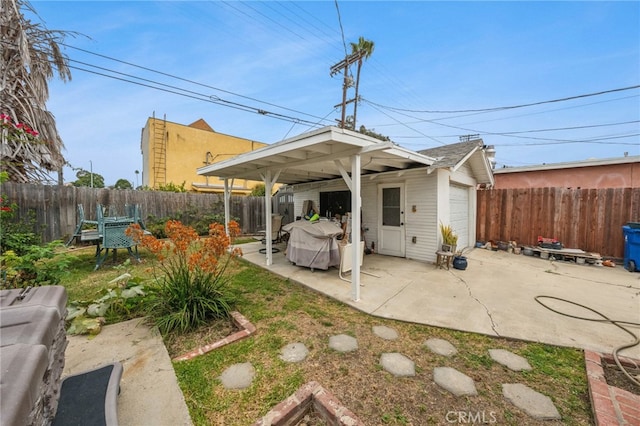 3927 W 58th Pl, Los Angeles, CA 90043 - back of house with an outbuilding, a fenced backyard, and a patio area