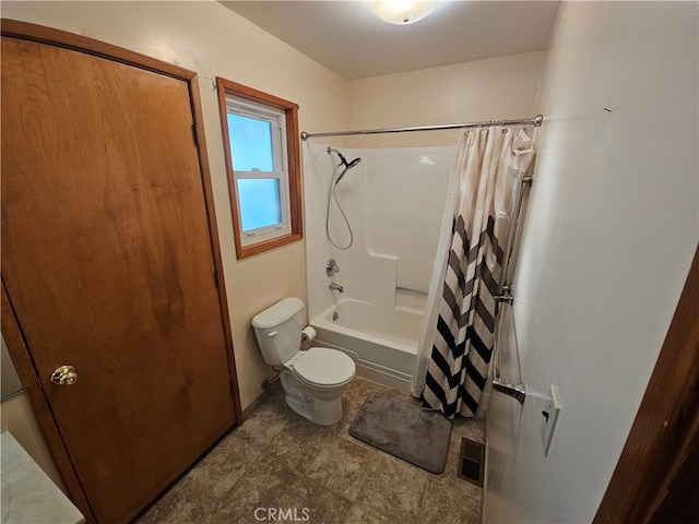 bathroom featuring shower / bath combo with shower curtain and toilet