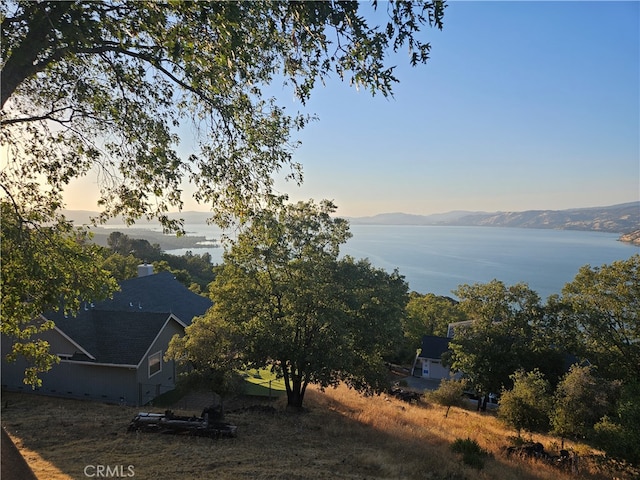 exterior space with a water and mountain view