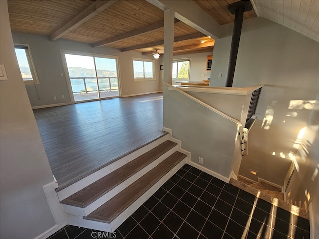 stairs featuring wooden ceiling, wood-type flooring, vaulted ceiling with beams, and plenty of natural light