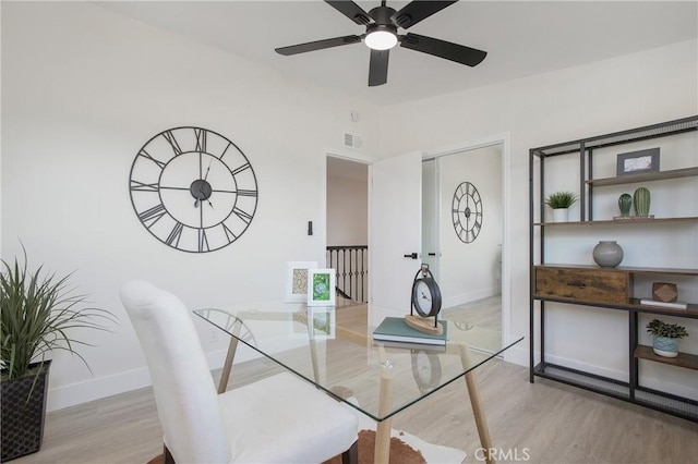 dining space with light hardwood / wood-style floors and ceiling fan