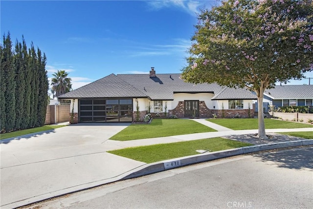 view of front of house with a front yard and a garage