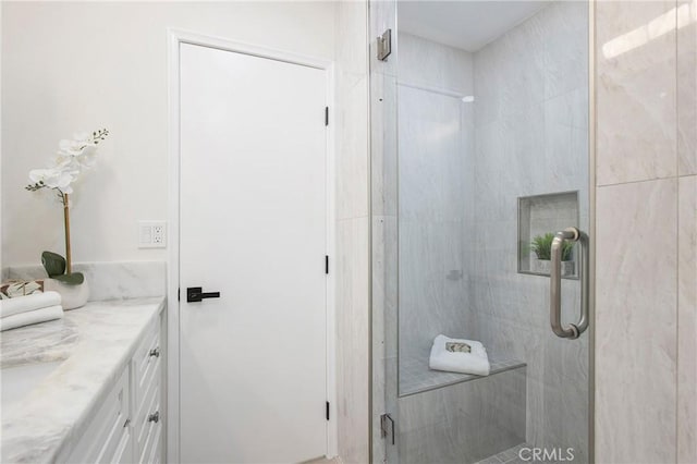 bathroom with vanity and a shower with shower door