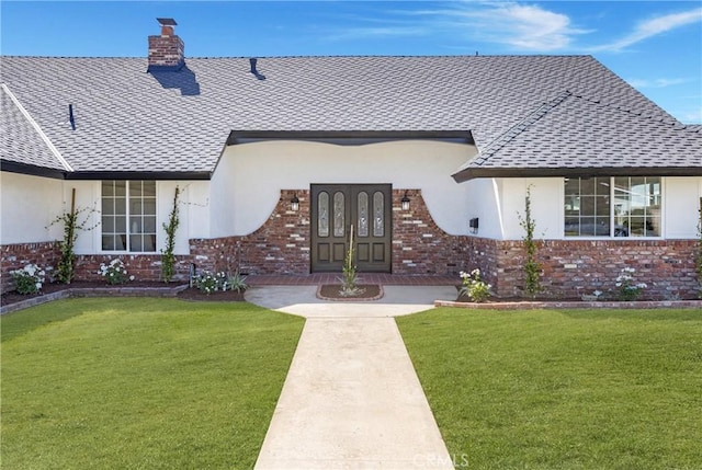 exterior space with french doors and a yard