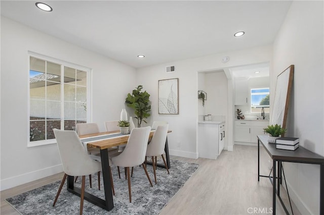 dining space with light hardwood / wood-style floors