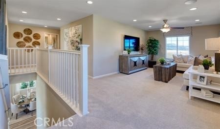 carpeted living room featuring ceiling fan