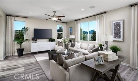 living room featuring hardwood / wood-style floors and ceiling fan