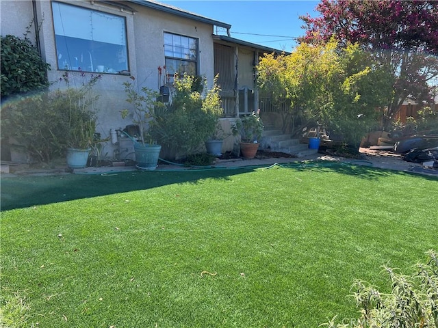 view of side of home with a lawn