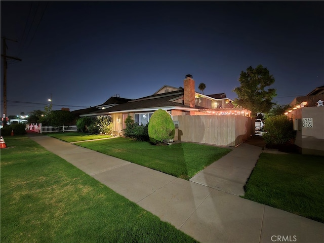 view of front of property with a yard